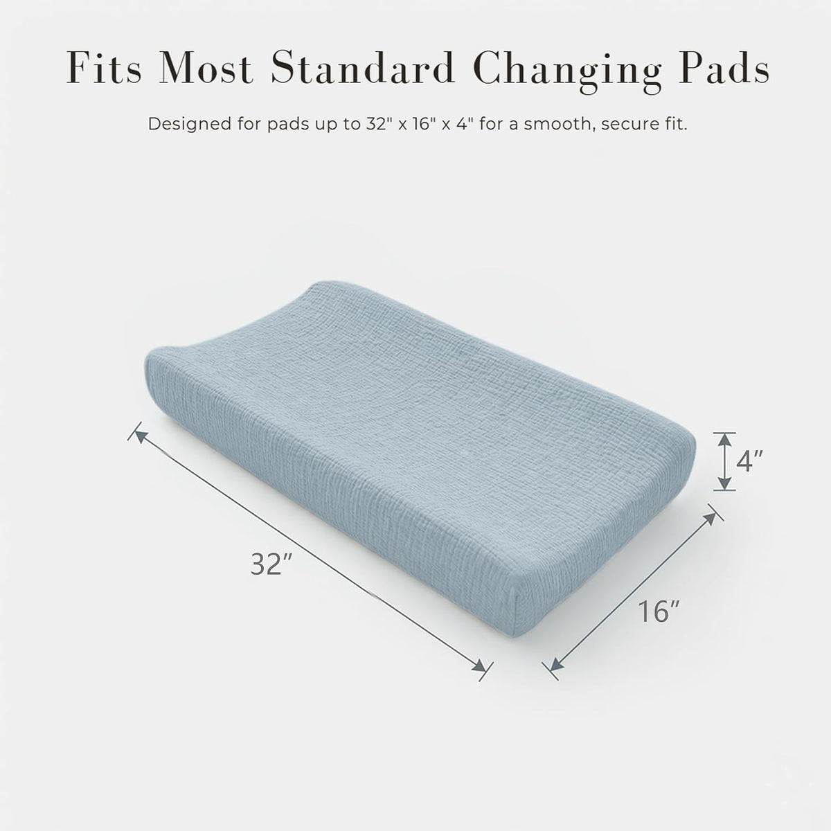 Changing pad cover in soft blue textured muslin fabric shown on a contoured pad from a three-quarter angle. Dimension arrows indicate the cover fits pads up to 32" x 16" x 4". Text reads 'Fits Most Standard Changing Pads.'