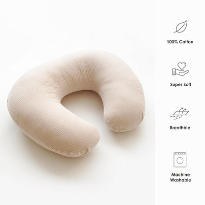 U-shaped nursing pillow cover in light beige textured muslin cotton, shown on a white background. Feature icons on the right list: 100% Cotton, Super Soft, Breathable, and Machine Washable.