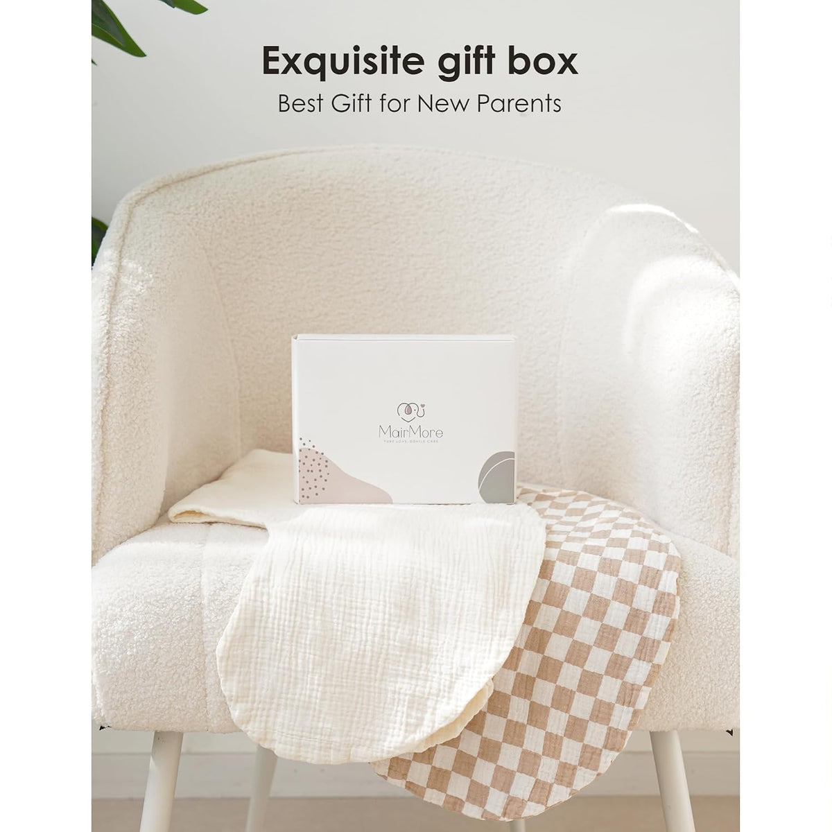 White gift box branded 'MairMore' resting on a cream boucle armchair, flanked by two muslin fabric covers: one solid cream and one tan-and-white checkered pattern. Text reads 'Exquisite gift box - Best Gift for New Parents.'