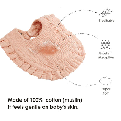 Peach muslin baby bandana bib with ruffled edge, shown flat with a water droplet demonstrating absorption. Dashed lines point to icons labeled Breathable, Excellent absorption, and Super Soft. Text reads: Made of 100% cotton (muslin). It feels gentle on baby's skin.
