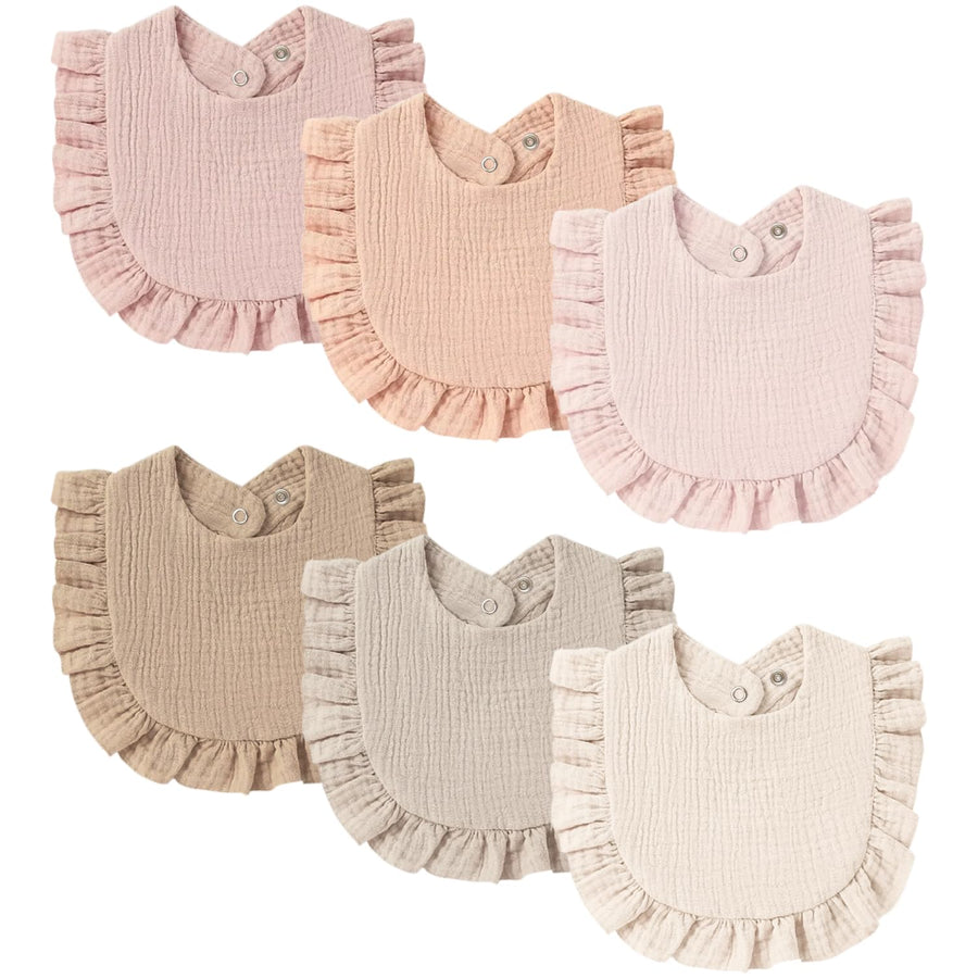 Six ruffled baby bibs in two rows on a white background. Top row shows dusty rose, peach, and pale lavender bibs; bottom row shows tan, light gray, and cream bibs. All feature textured muslin fabric and snap closures.