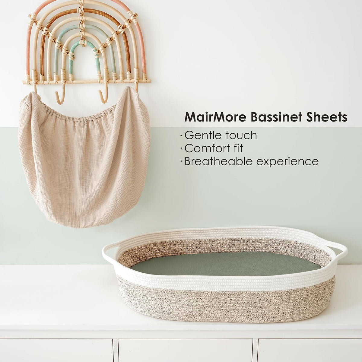MairMore Bassinet Sheets promotional image showing a beige muslin fitted sheet hanging on a decorative rainbow wall hook, and an oval rope bassinet with a sage green fitted sheet on a white surface. Text lists: Gentle touch, Comfort fit, Breathable experience.