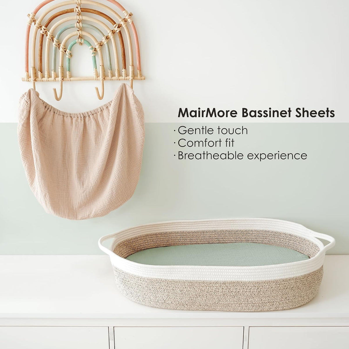 MairMore Bassinet Sheets promotional image showing a soft pink muslin fitted sheet draped over a decorative rainbow hanger, alongside an oval rope bassinet. Text highlights: Gentle touch, Comfort fit, Breathable experience.