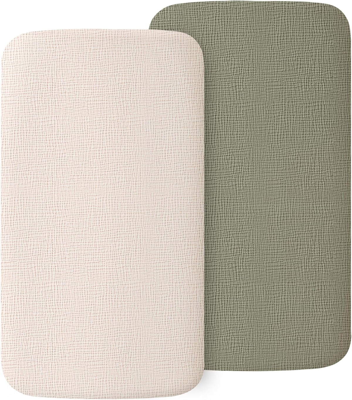 Two rectangular fitted bassinet sheets with rounded corners displayed side by side. Left sheet is cream/off-white, right is muted sage green. Both show a visible woven muslin texture on a white background.